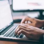 Hands typing on a laptop in a modern workspace, symbolizing digital marketing strategy at DoProFlow.
